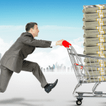 A man pushing a shopping cart full of stacks of fast personal loans money