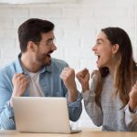 Happy couple celebrating a successful online payday loan approval in Oklahoma with no credit check.