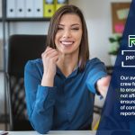 A woman sitting at a desk in front of a computer looking for personal loans near me