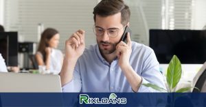man talking over the cellphone while using a laptop