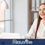 A woman sitting at a desk talking on a cell phone about payday loans in Louisiana