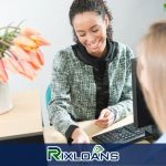 A woman sitting at a desk with a calculator discussing New Jersey payday loans