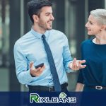 A woman talking to a man in a blue shirt and tie discussing payday loans in Arizona