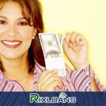 A woman holding a bundle of money obtained from a same day loan in front of her face