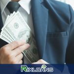 A man in a suit holding a bundle of money obtained from a payday loan in Michigan