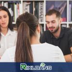 A man and a woman sitting at a table in front of a bookcase trying to find out how many payday loans they can have in Ohio