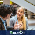 A woman talking to a man in a library on ways to consolidate payday loans in Illinois