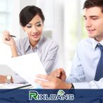 A man and a woman sitting at a desk learning about how to consolidate payday loans in Massachusetts