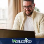 A man sitting in front of a laptop computer reading about payday loans in Las Vegas