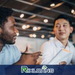 Two men sitting at a table talking to each other about payday loans in Los Angeles