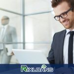 A man in a suit and tie looking at a laptop reading about payday loans in Memphis