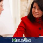 A woman in a red coat talking to another woman about installment loans Connecticut