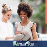 Two women are looking at installment loans on a tablet in New Jersey