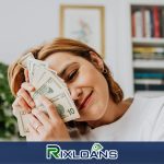 A woman holding a bundle of money from installment loans South Carolina in front of her face