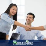 A group of people shaking hands in an office discussing installment loans Nebraska