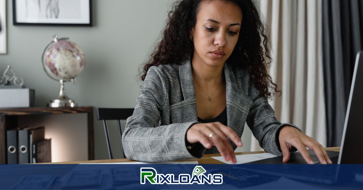 A woman sitting at a desk searching for installment loans on a laptop in Vermont